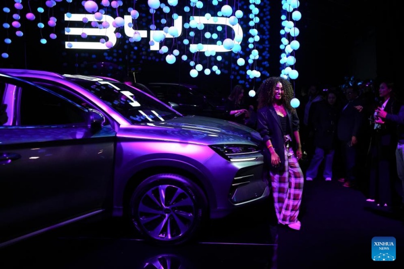 Imagen del 23 de septiembre de 2025 de una mujer posando junto a una camioneta durante el evento de lanzamiento de dos potentes camionetas de la compa?ía china de tecnología BYD, en Bogotá, capital de Colombia. La compa?ía china de tecnología BYD presentó en Bogotá su lanzamiento más relevante de 2025 en el mercado colombiano: dos potentes camionetas con tecnologías híbrida y eléctrica. (Xinhua/Andrés Moreno)